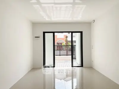 Spacious empty room with large windows and glossy tiled floor