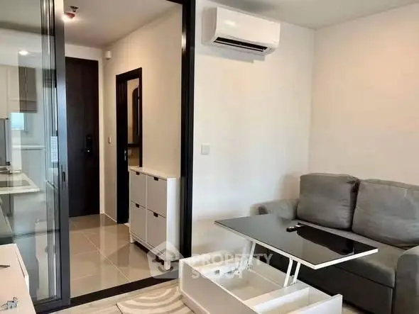 Modern living room with sleek furniture and air conditioning in a stylish apartment.