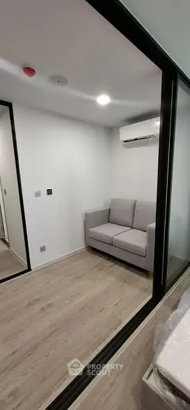 Modern compact living room with glass walls and air conditioning