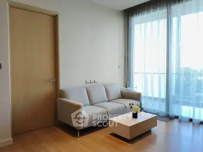 Modern living room with elegant sofa and large window offering natural light