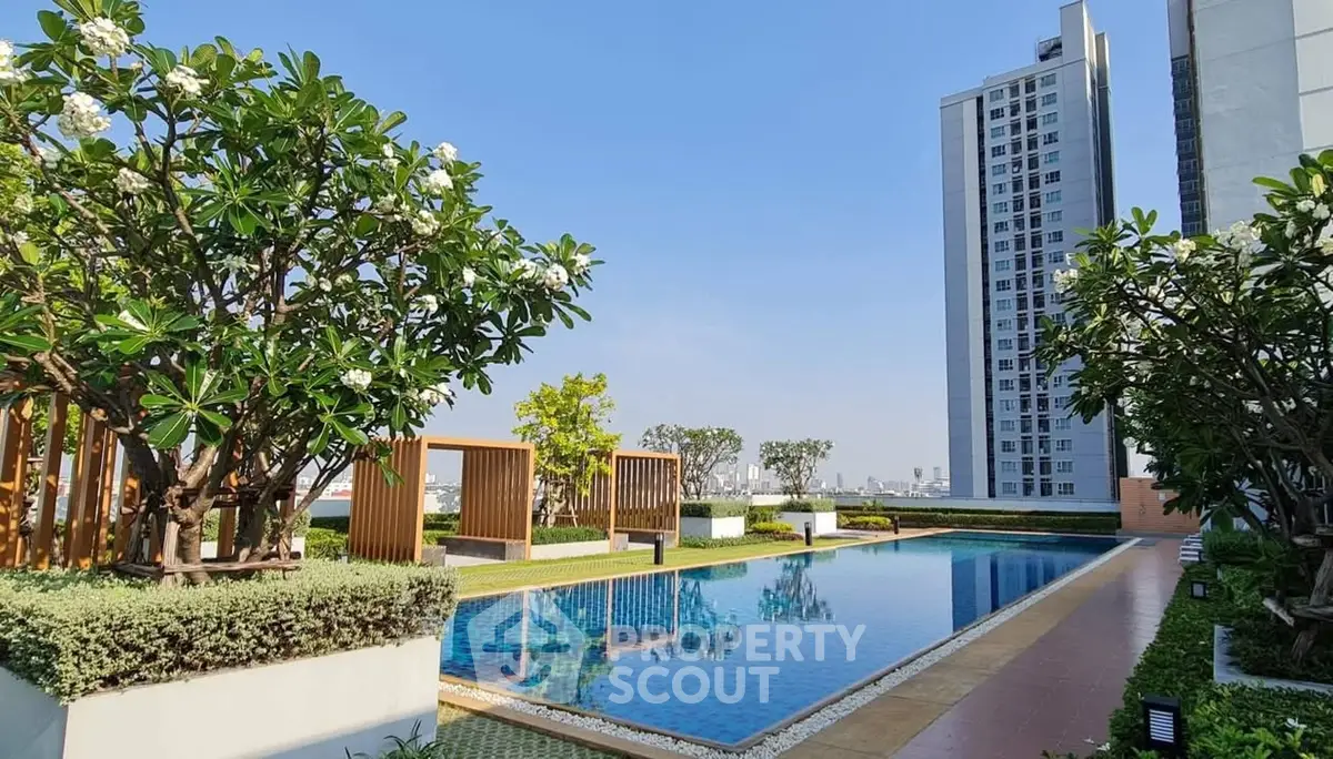 Luxurious rooftop pool with stunning city views and lush greenery