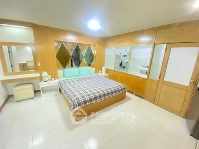 Spacious bedroom with modern decor and ample natural light