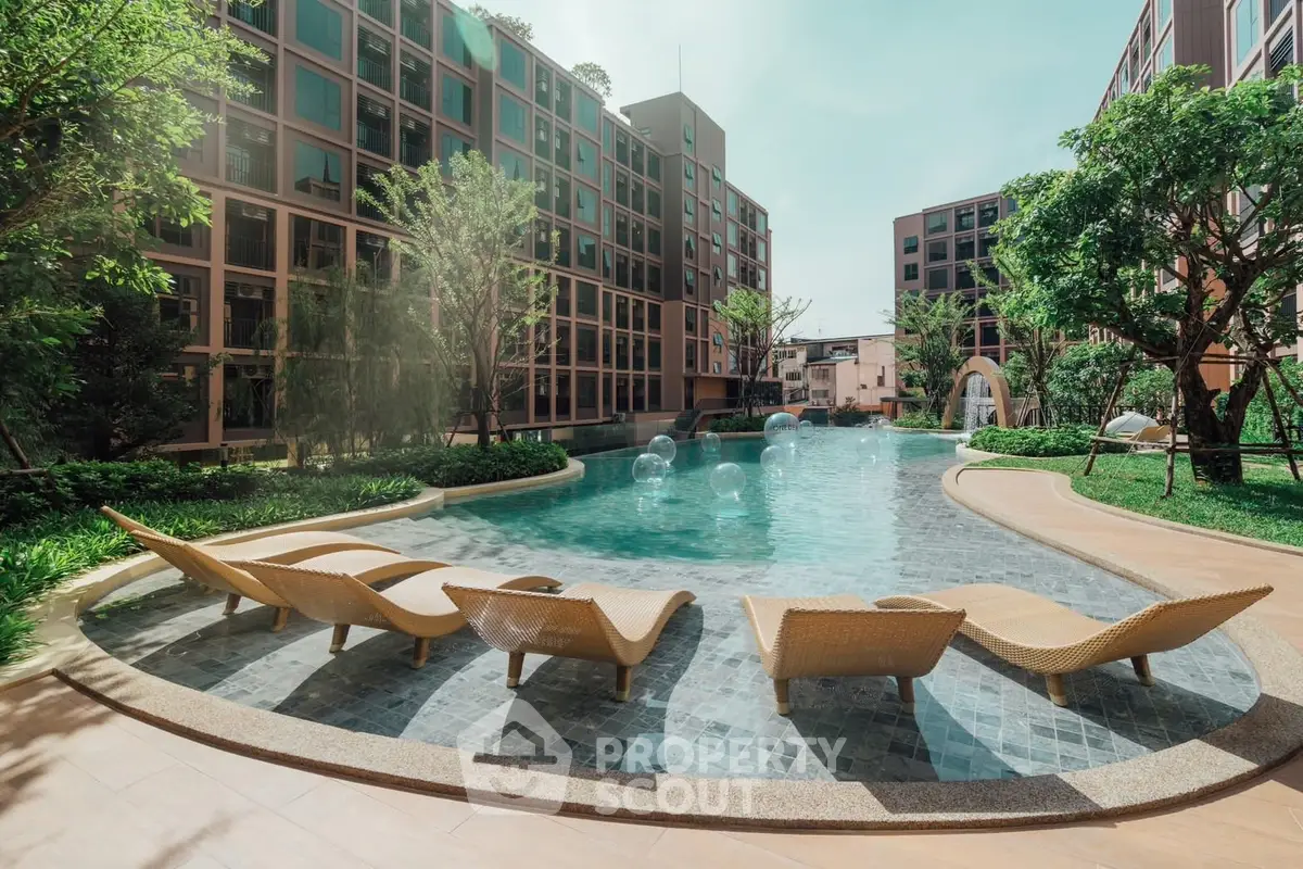 Luxurious apartment complex with stunning pool and lush greenery, perfect for relaxation and leisure.