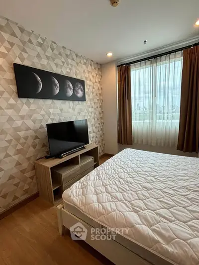Modern bedroom with geometric wallpaper and large window offering city views.