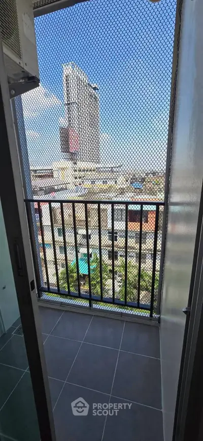 Urban balcony with city view and protective mesh, ideal for safety and enjoying skyline vistas.