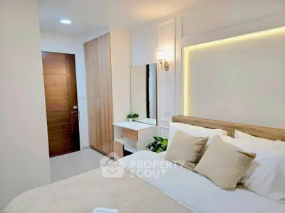Modern bedroom with cozy bed, wooden wardrobe, and elegant lighting