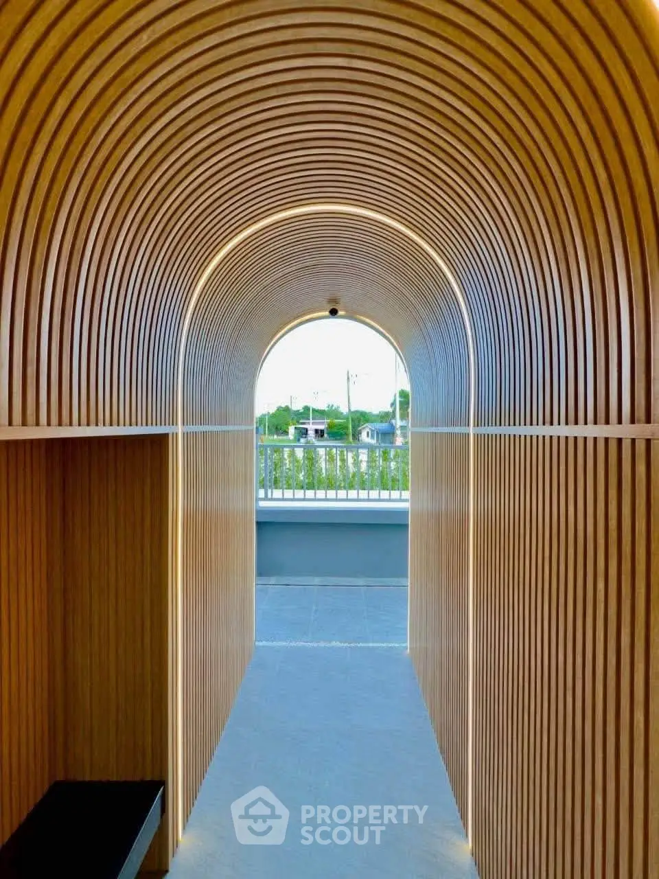 Stunning modern architectural hallway with wooden arches leading to an outdoor terrace.