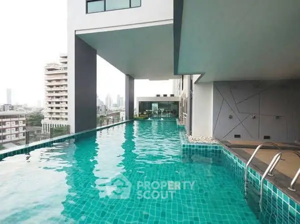 Luxurious rooftop infinity pool with stunning cityscape views in modern high-rise building.