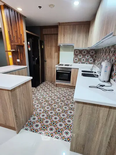 Modern kitchen with stylish patterned tiles and wooden cabinetry