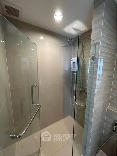 Modern bathroom with glass shower enclosure and sleek tile design