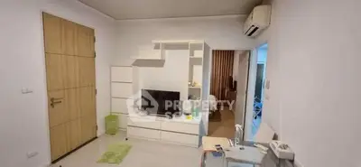 Modern living room with TV unit and air conditioning in a cozy apartment.