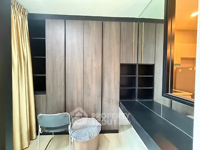 Modern study room with sleek wooden cabinetry and large window