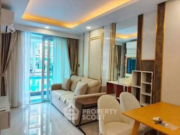 Modern living room with pool view, elegant decor, and cozy seating area.