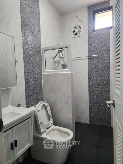 Modern bathroom with sleek tile design and compact layout