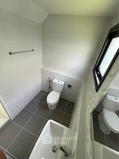 Modern bathroom with sleek white tiles and contemporary fixtures