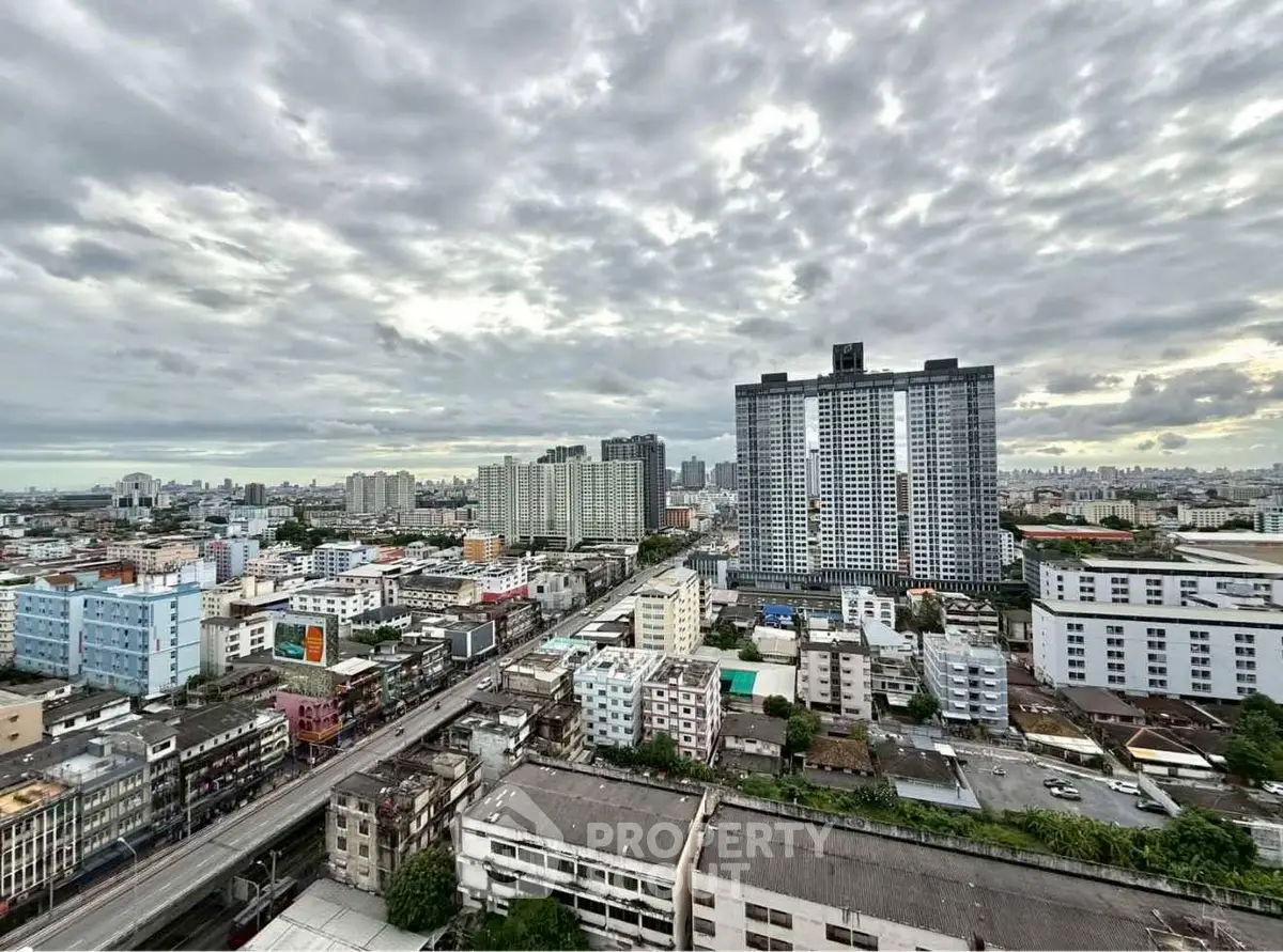 Stunning cityscape view with high-rise buildings under a dramatic cloudy sky, perfect for urban living.