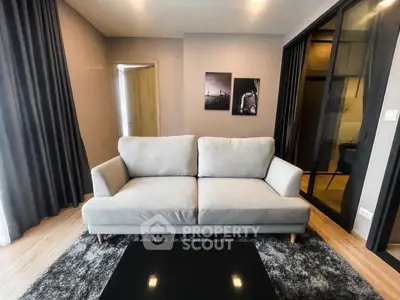 Modern living room with cozy sofa and stylish decor in a contemporary apartment.