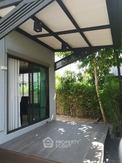 Modern patio with sleek design and lush greenery, perfect for outdoor relaxation.
