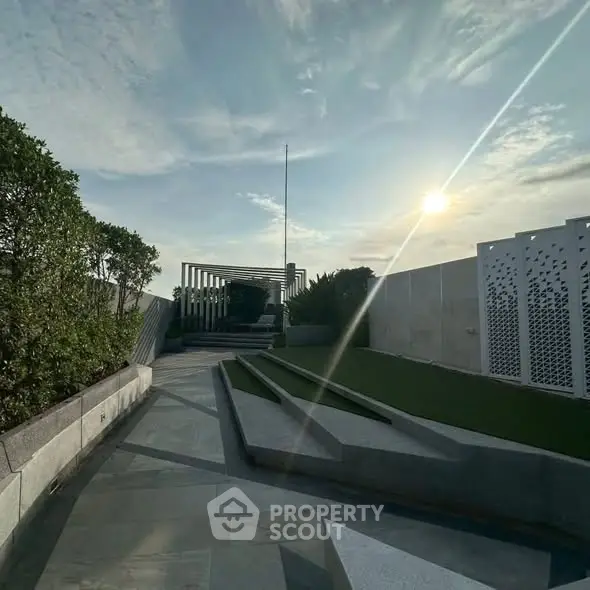 Stunning rooftop garden with modern design and scenic views at sunset.