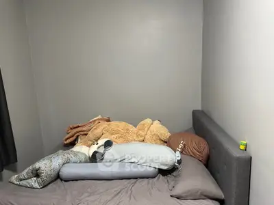 Cozy bedroom with plush toys and modern gray bedding
