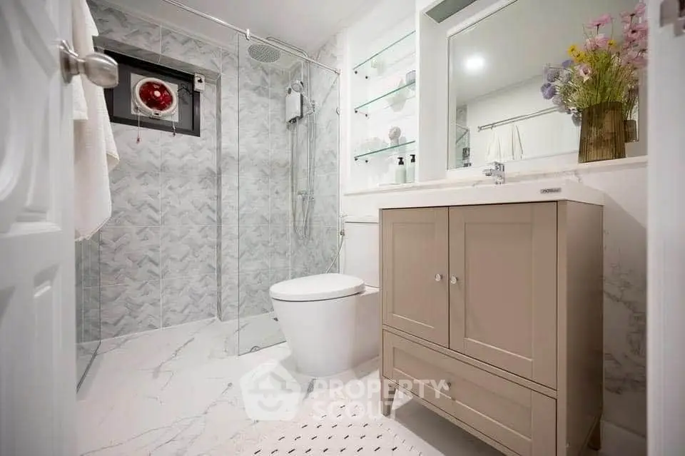 Modern bathroom with sleek design, glass shower, and elegant vanity.