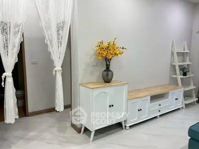 Elegant living room with stylish white furniture and decorative vase, showcasing modern interior design.