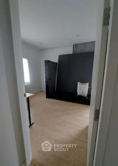 Spacious room with wooden flooring and modern decor