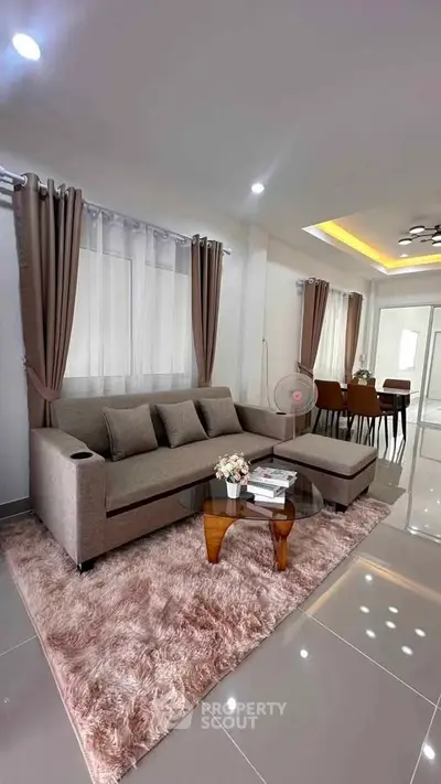Stylish modern living room with plush rug and elegant dining area