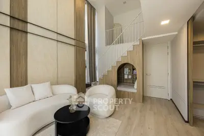 Modern living room with stylish furniture and unique loft design, featuring a cozy reading nook and elegant decor.