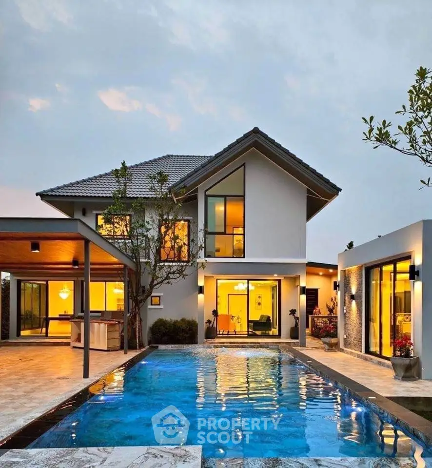 Stunning modern house with pool and elegant exterior lighting at dusk.