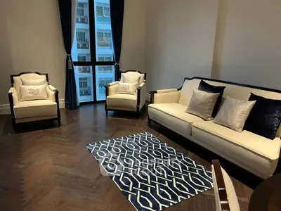 Elegant living room with stylish furniture and large window in modern apartment.