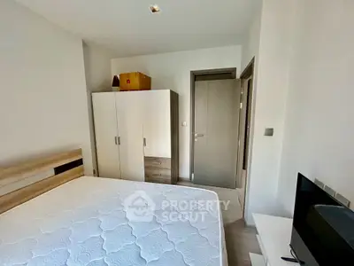 Modern bedroom with sleek wardrobe and comfortable bed in a minimalist design.