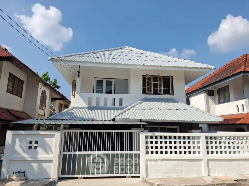 Charming two-story house with modern design and spacious front yard in a serene neighborhood.