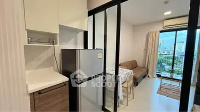 Modern apartment with open kitchen and living room, featuring a balcony with city view.