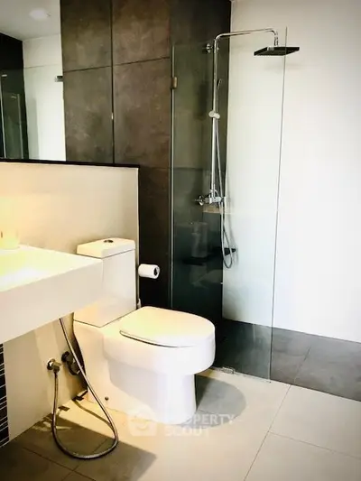 Modern bathroom with sleek shower and contemporary fixtures in a stylish apartment.