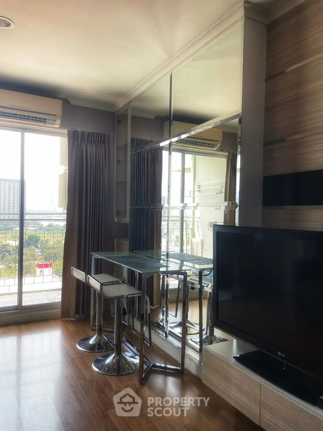 Modern living room with sleek furniture and city view balcony