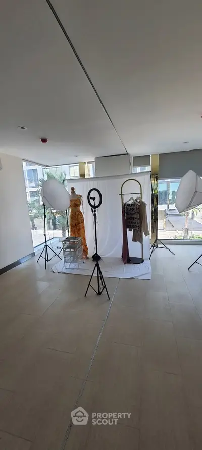 Spacious interior setup for fashion photography in modern building lobby.