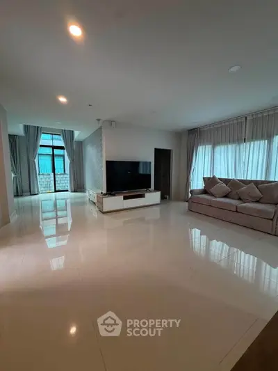 Spacious modern living room with sleek design and large windows for natural light.