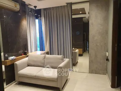Modern living room with sleek design, featuring a cozy sofa and elegant curtains.