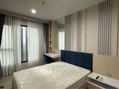 Modern bedroom with stylish decor and large windows in a contemporary apartment.