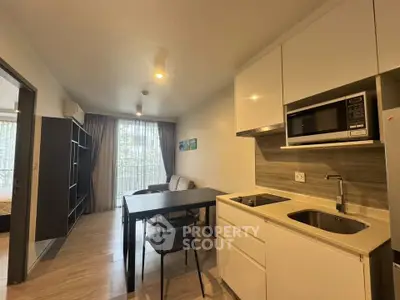Modern open-layout kitchen and living area with sleek design and natural light.