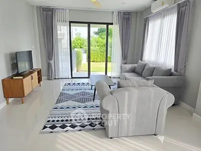 Spacious modern living room with large windows and stylish furniture