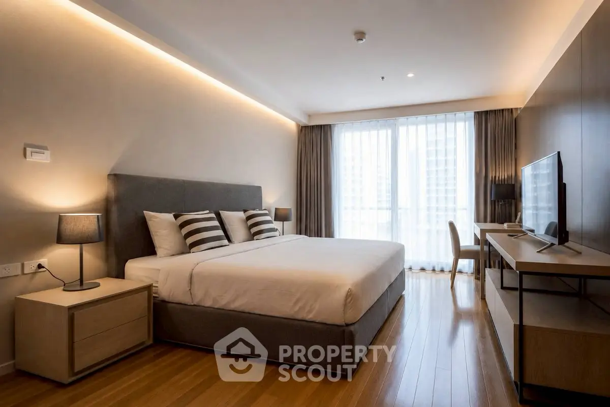 Modern bedroom with stylish decor and large window in luxury apartment