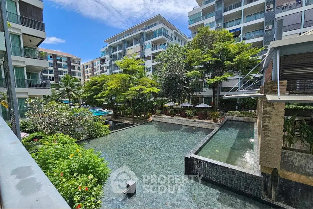 Luxurious condominium with serene pool and lush garden view