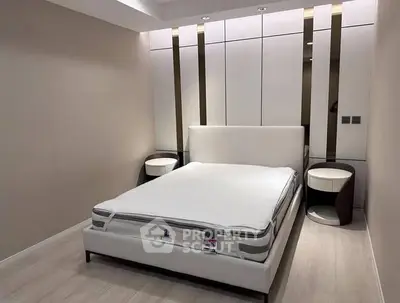 Modern bedroom with sleek design and minimalist decor, featuring a comfortable bed and stylish side tables.