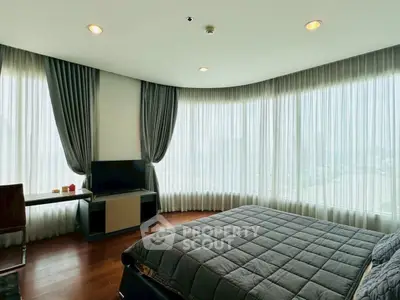 Luxurious bedroom with floor-to-ceiling windows and elegant decor