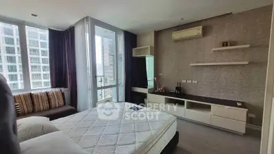 Modern bedroom with balcony in high-rise apartment, featuring stylish decor and ample natural light.