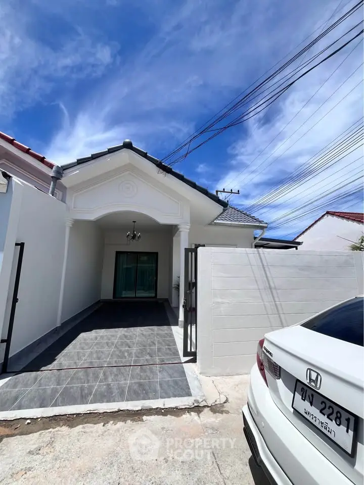 Charming single-story home with gated entrance and driveway, perfect for modern living.