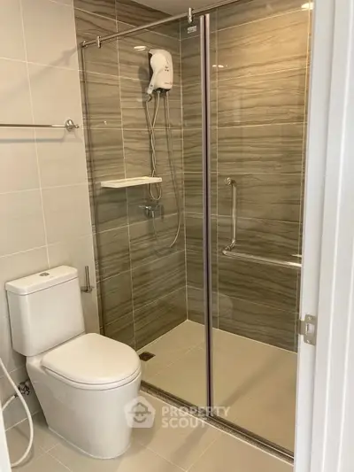 Modern bathroom with glass shower enclosure and sleek fixtures