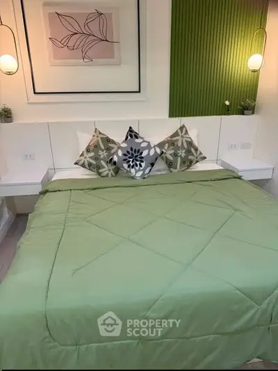 Cozy bedroom with stylish decor and green bedding, perfect for relaxation.